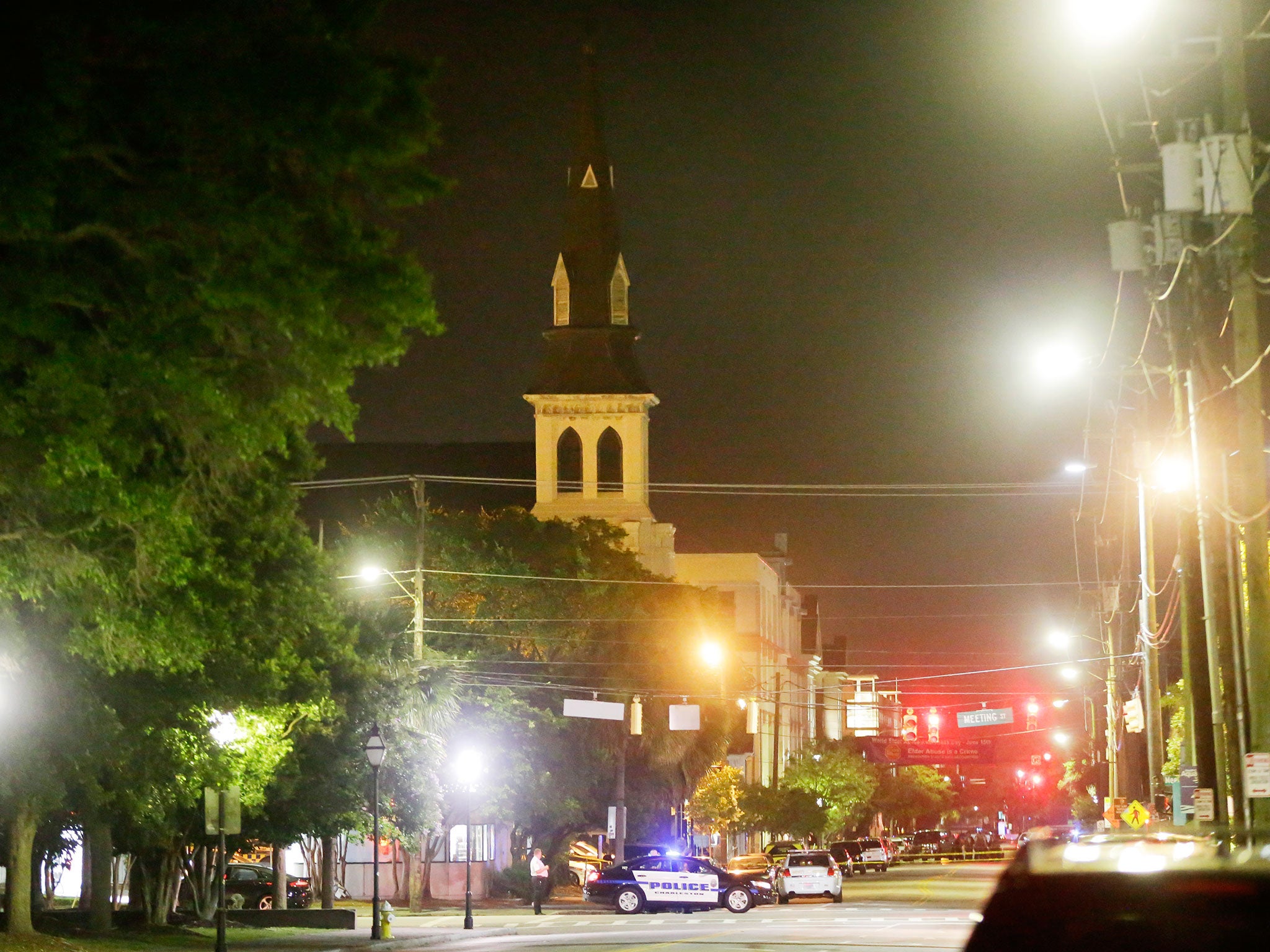 The steeple of Emanuel AME Church is visible as police close off a section of Calhoun Street following a shooting in Charleston