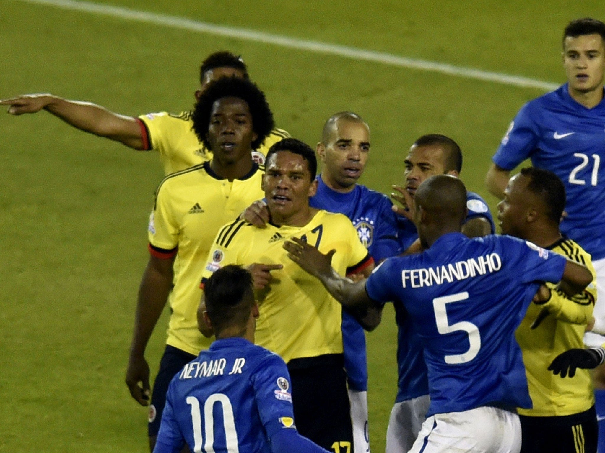 Neymar clashes with Colombia's Carlos Bacca at the final whistle