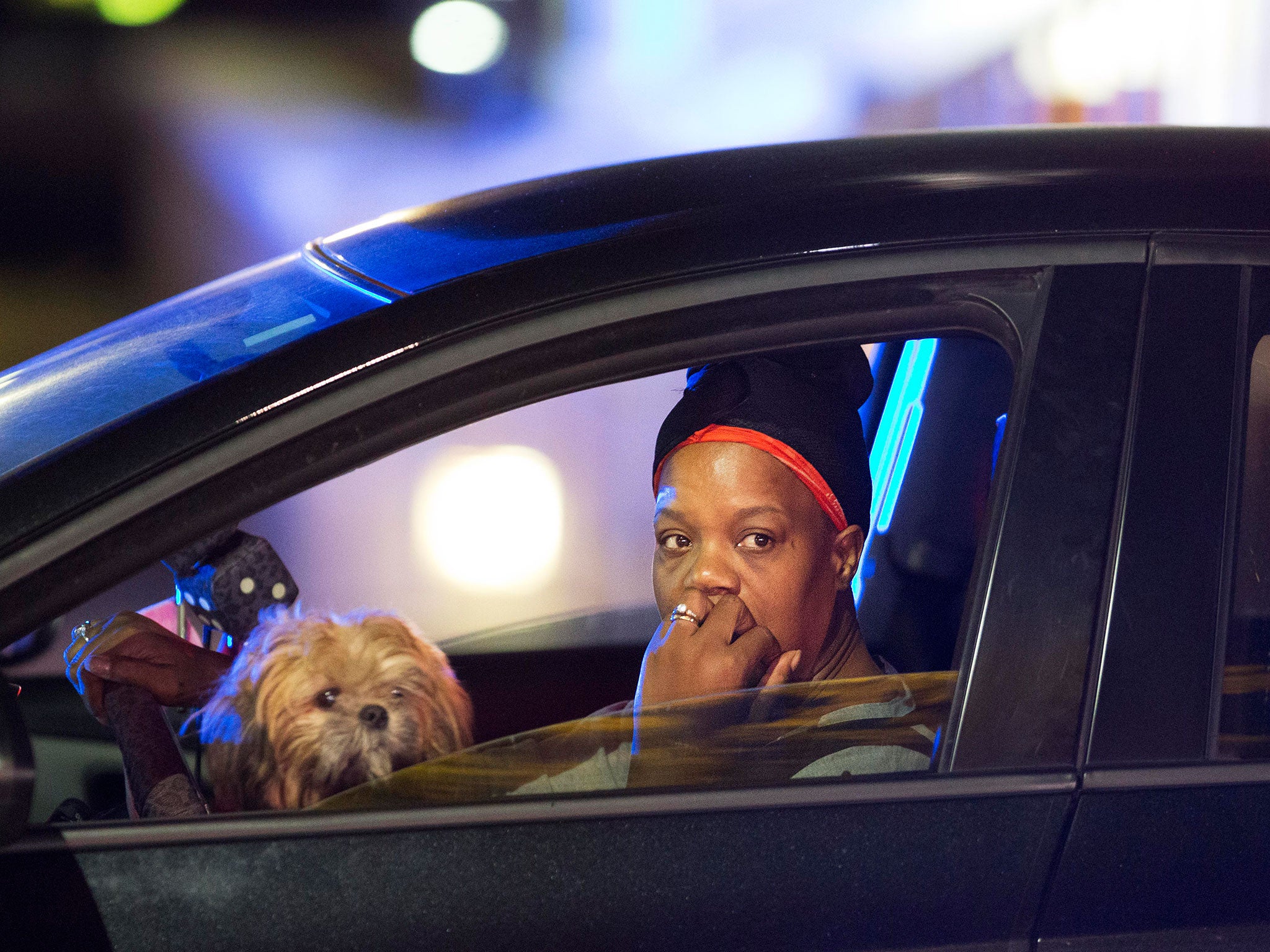 A passing motorist looks out her window as she stops at an intersection down the street from the Emanuel AME Church