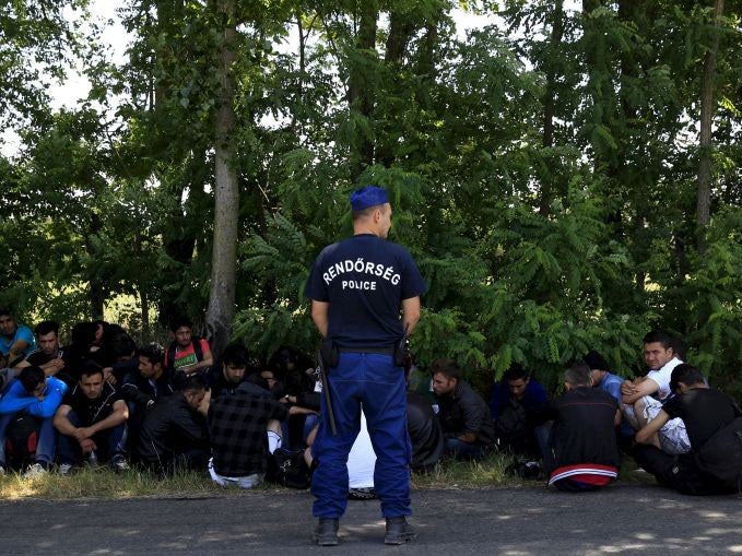 Iraqi migrants being detained by Hungarian police