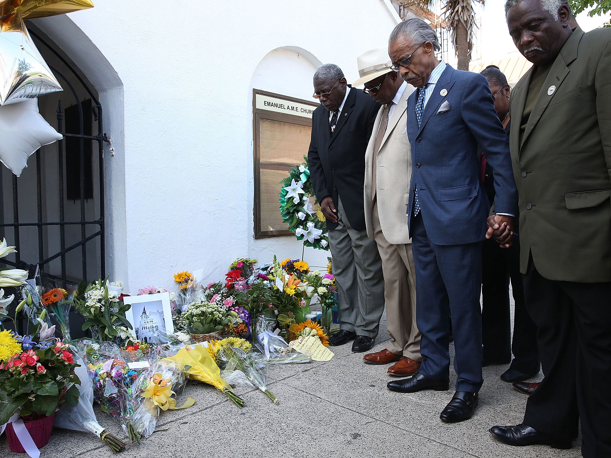 Rev Al Sharpton holds a group prayer outside Emanuel African Methodist Episcopal Church where nine people were killed