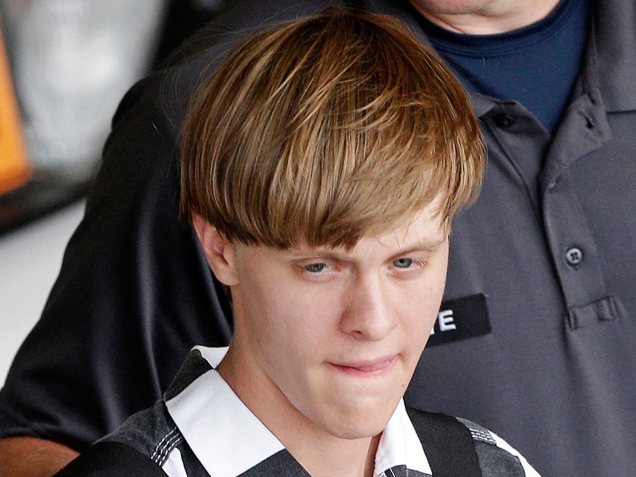 Charleston shooting suspect Dylann Storm Roof is escorted from the Cleveland County Courthouse in Shelby