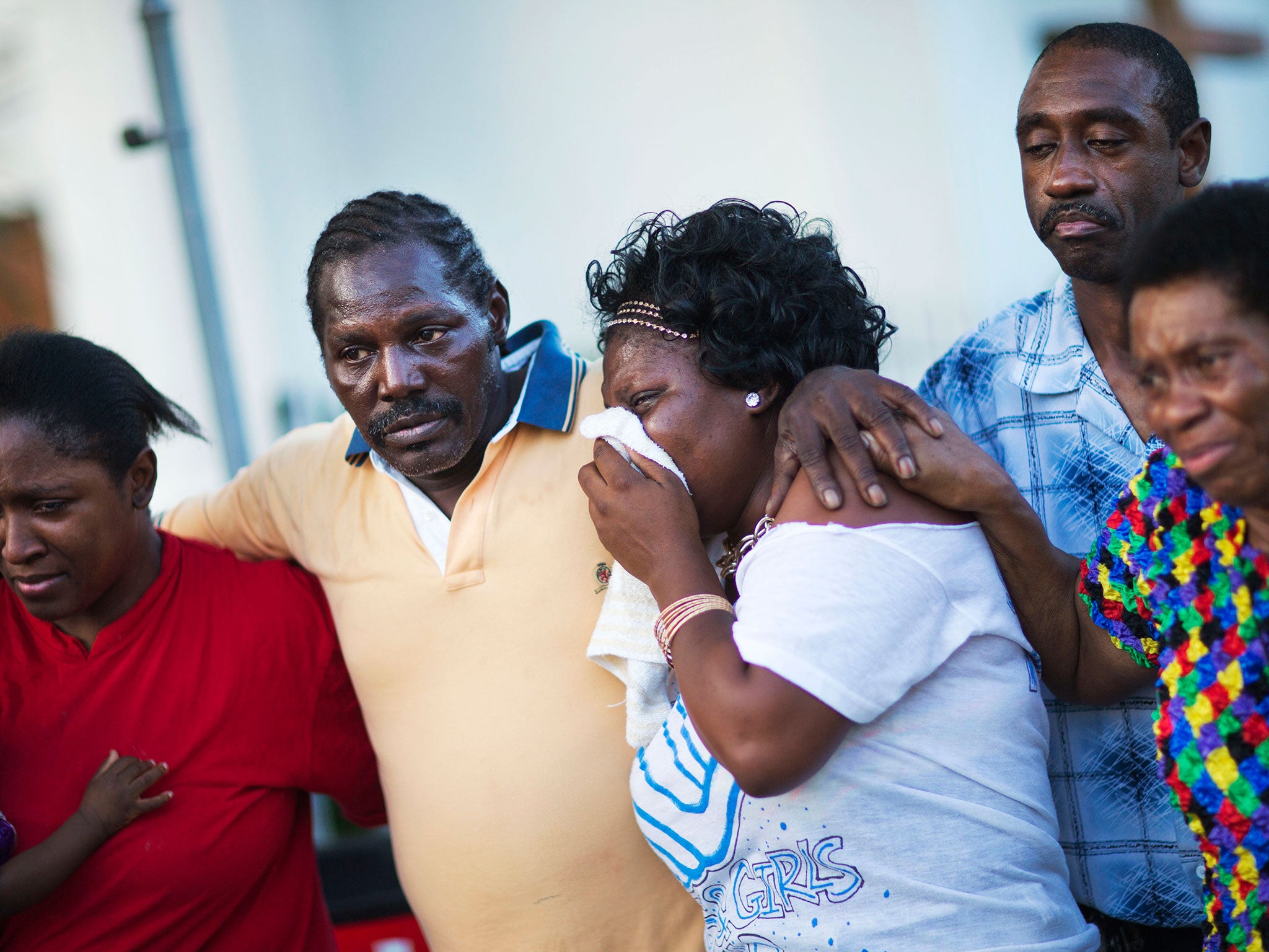 Gary and Aurelia Washington, center left and right, the son and granddaughter of Ethel Lance who died in the shooting