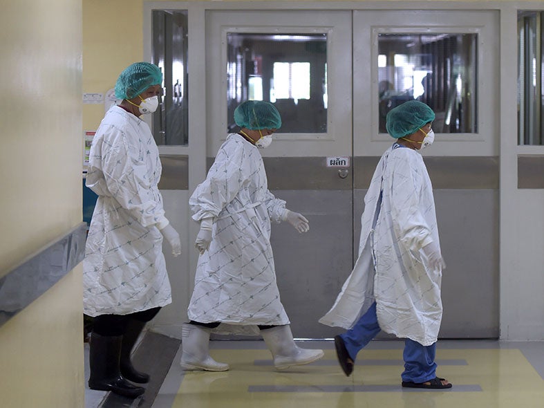 Hospital staff working in the isolation ward in Thailand where the 75-year-old man is being treated for Mers