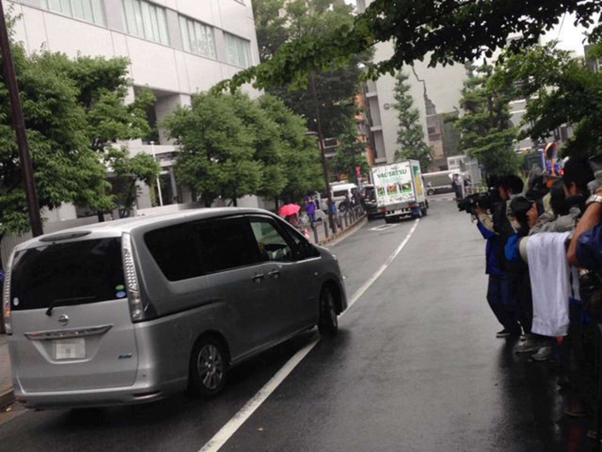 A van carrying Toyota Motor's managing officer and chief communications officer Julie Hamp leaves a police office to a prosecutors office in Tokyo on June 19, 2015