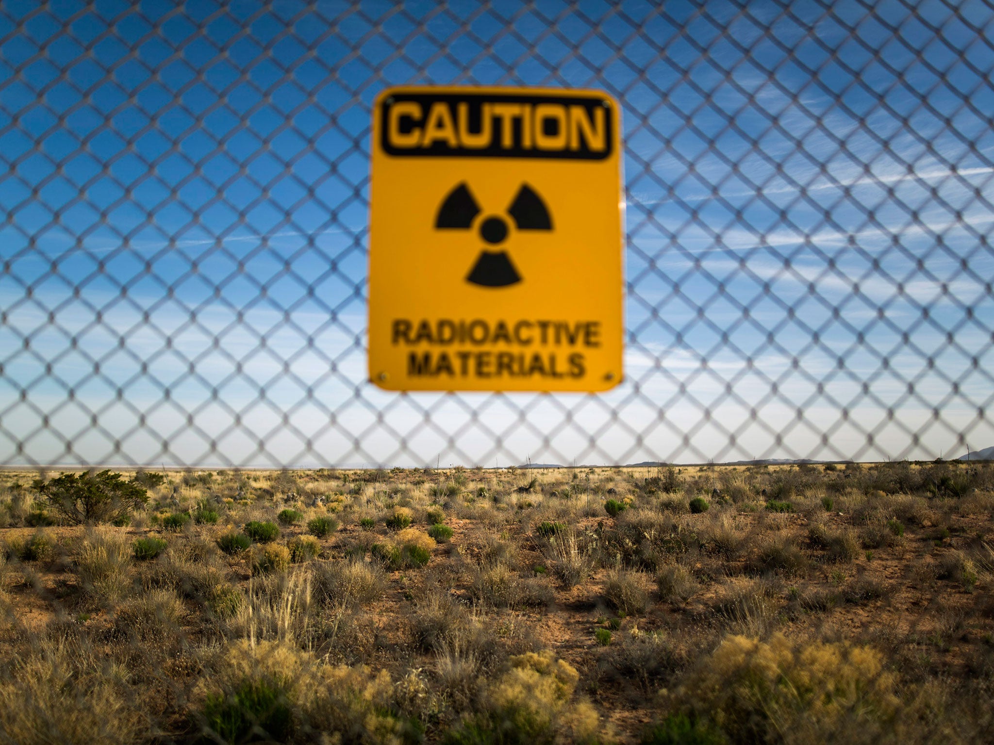 A warning sign is seen on a fence surrounding the Trinity Test Site, where on July 16, 1945 scientists working with the Manhattan Project detonated the world's first atomic bomb, on White Sands Missile Range just outside San Antonio, New Mexico