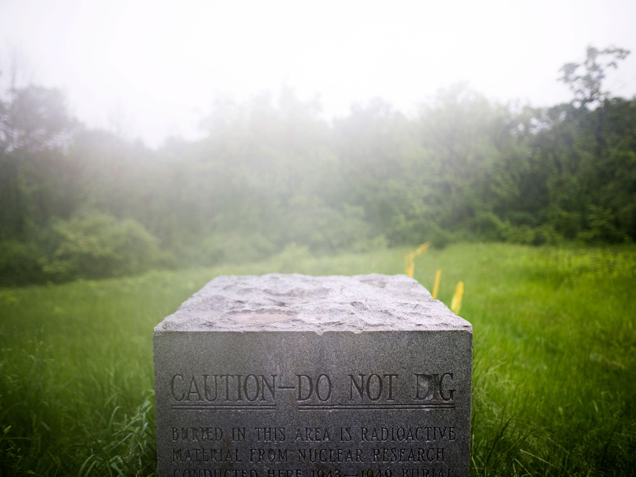 A concrete marker at a site known as 'Plot M,' which is located in a public park in suburban Chicago, warns visitors that radioactive waste from the Chicago Pile (the world's first nuclear reactor), as well as other nuclear experiments, is buried beneath the soil in Red Gate Woods, Illinois