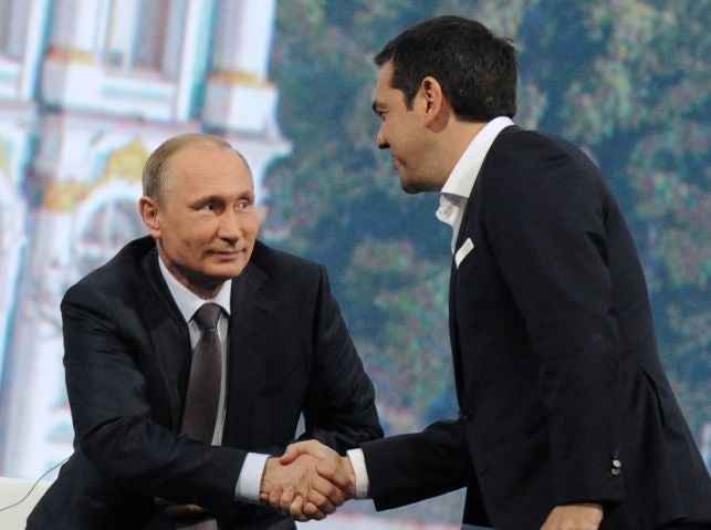Greek Prime Minister Alexis Tsipras shakes hands with Russian President Vladimir Putin during a session of the St. Petersburg International Economic Forum (SPIEF 2015) in St. Petersburg on June 19