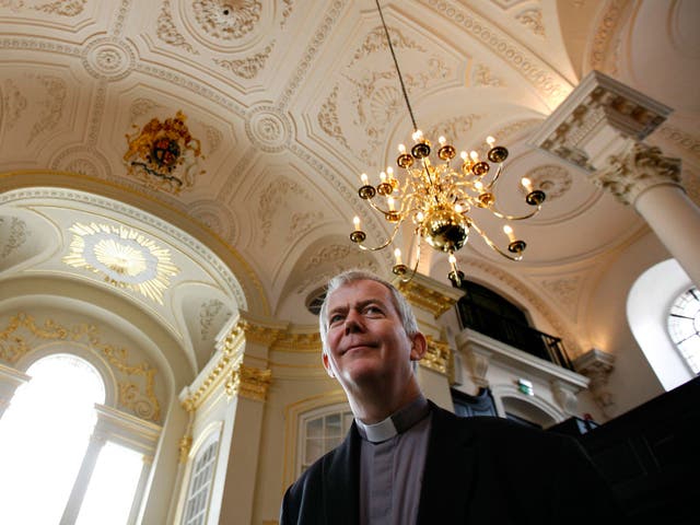 Reverand Nicholas Holtam talks to members of the media in the newly refurbished St Martin-in-the-Fields church in central London's Trafalgar Square