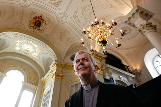 Reverand Nicholas Holtam talks to members of the media in the newly refurbished St Martin-in-the-Fields church in central London's Trafalgar Square