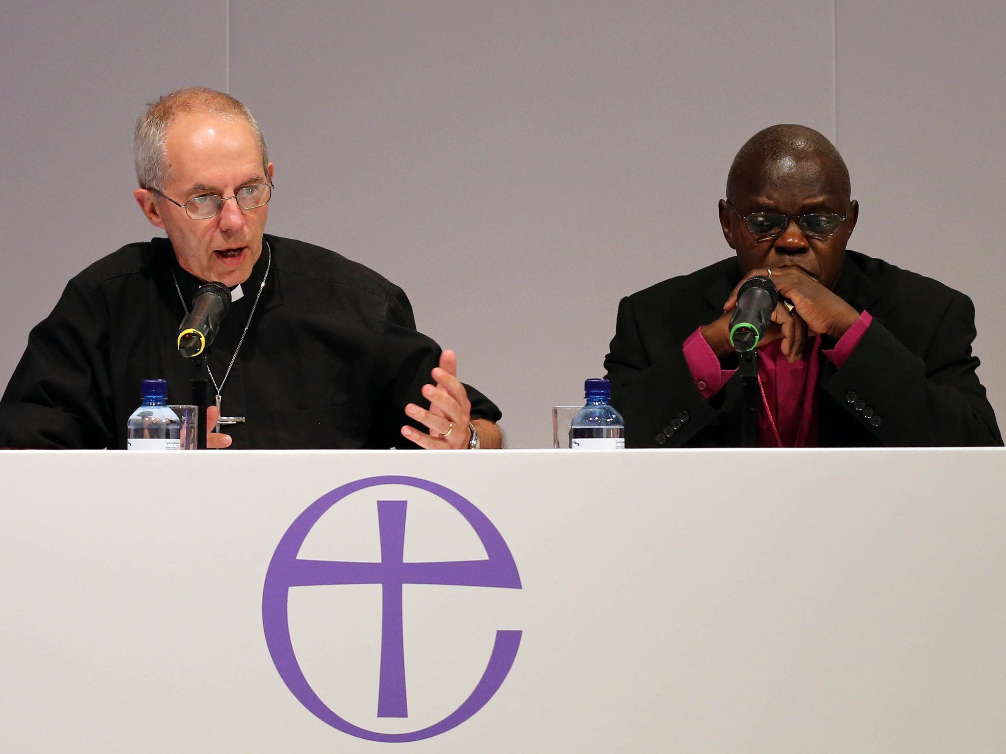 Archbishop of York John Sentamu (R) and Archbishop of Canterbury Justin Welby (L) speak at a press conference after Church of England General Synod 2014