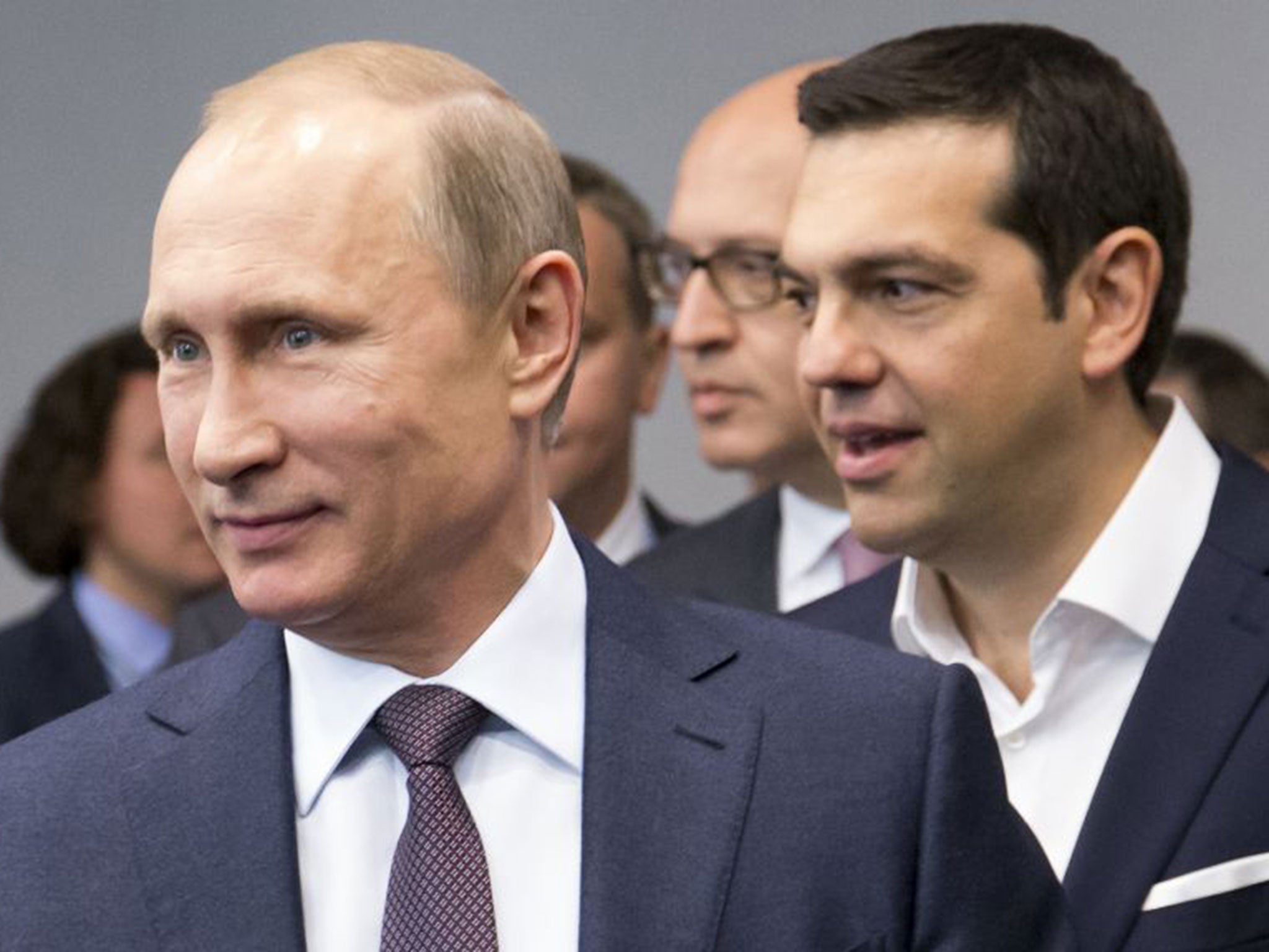 Russian President Vladimir Putin, foreground, and Greek Prime Minister, behind him, Alexis Tsipras arrive for their talks at the St. Petersburg International Investment Forum in St.Petersburg, Russia, Friday, June 19, 2015.