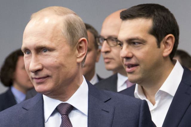 Russian President Vladimir Putin, foreground, and Greek Prime Minister, behind him, Alexis Tsipras arrive for their talks at the St. Petersburg International Investment Forum in St.Petersburg, Russia, Friday, June 19, 2015.