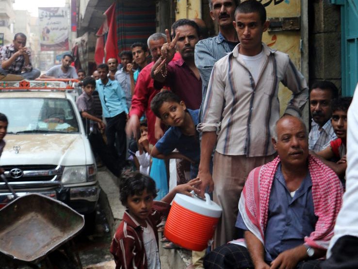 People in Aden queuing for food aid as the crisis across the country deepens
