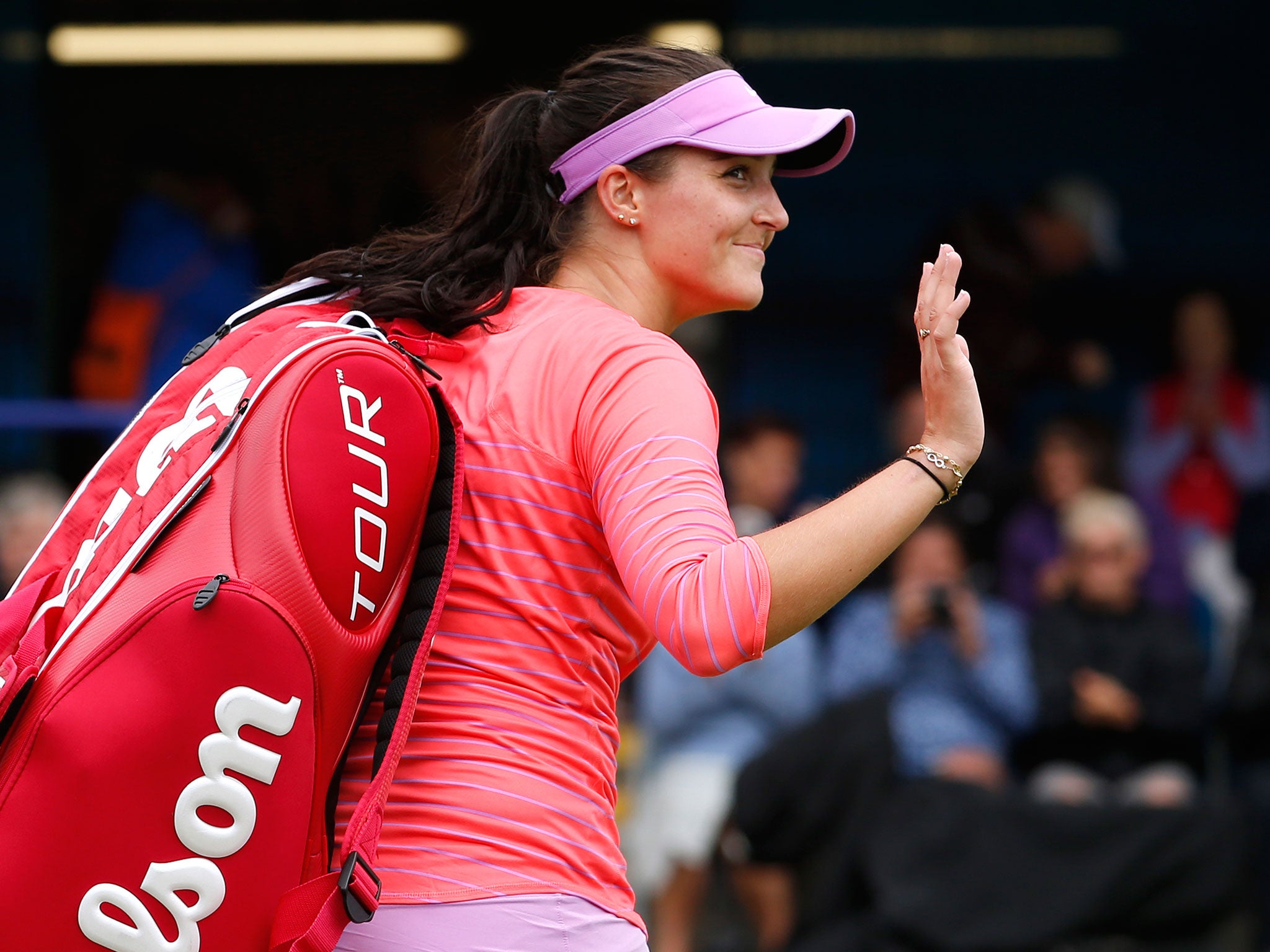 Robson waves to the crowd as she leaves the court