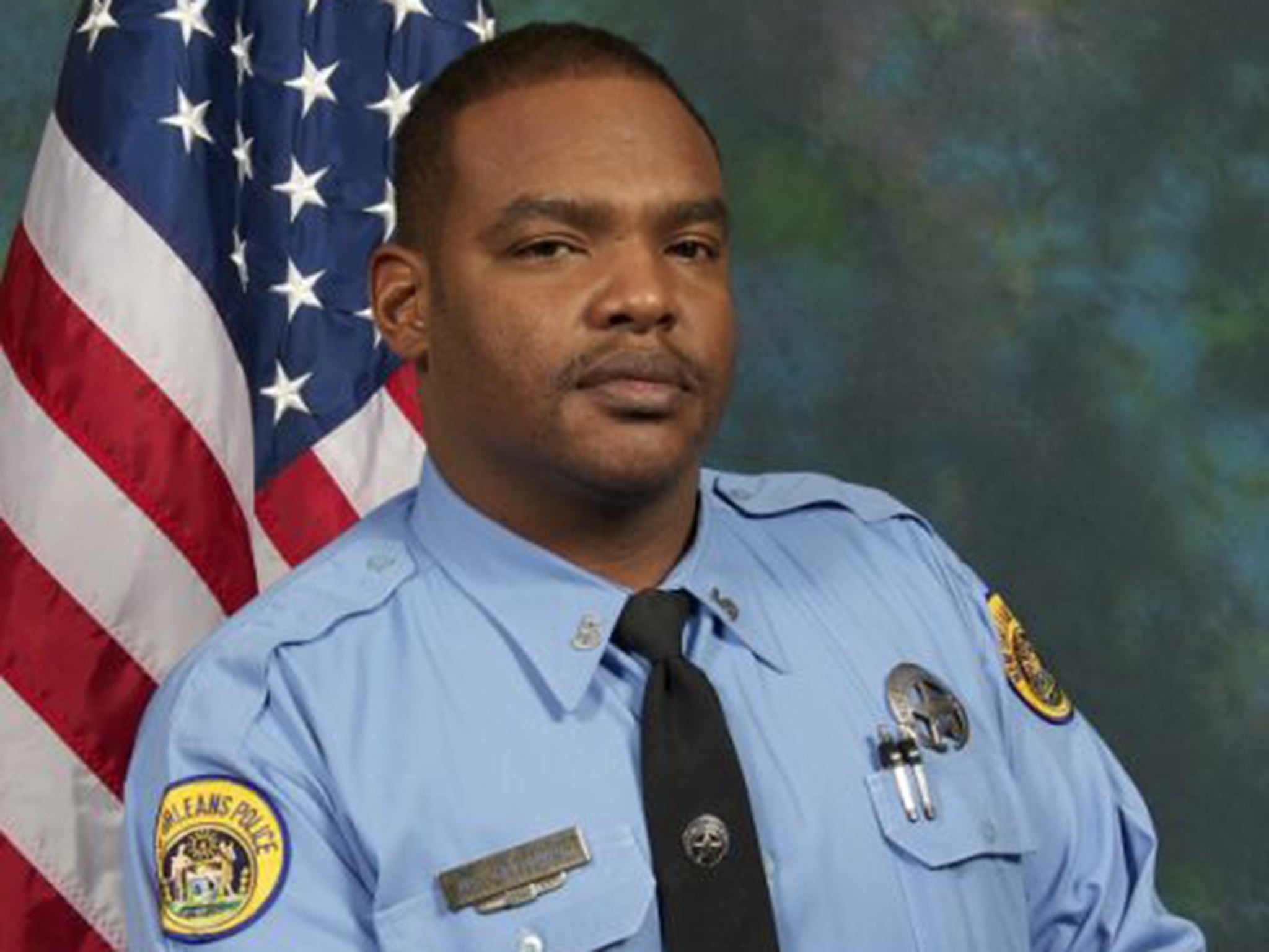 The New Orleans Police Department said Officer Daryle Holloway was shot while transporting a suspect