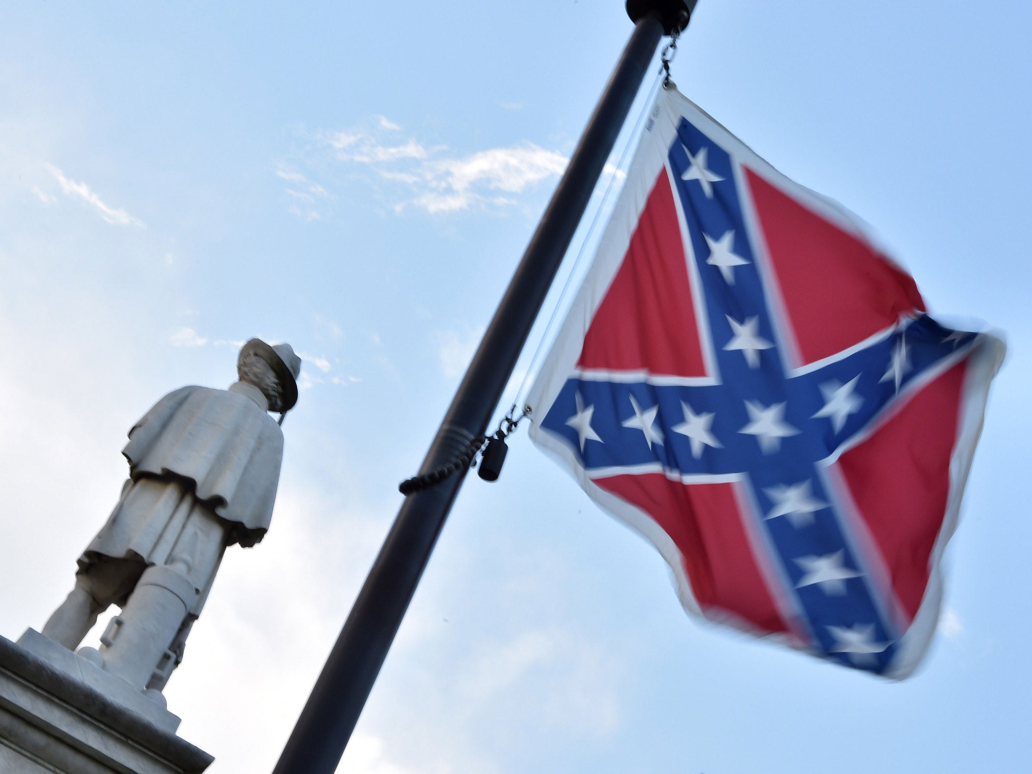 The Confederate flag is seen next to the monument of the victims of the Civil War in Columbia, South Carolina