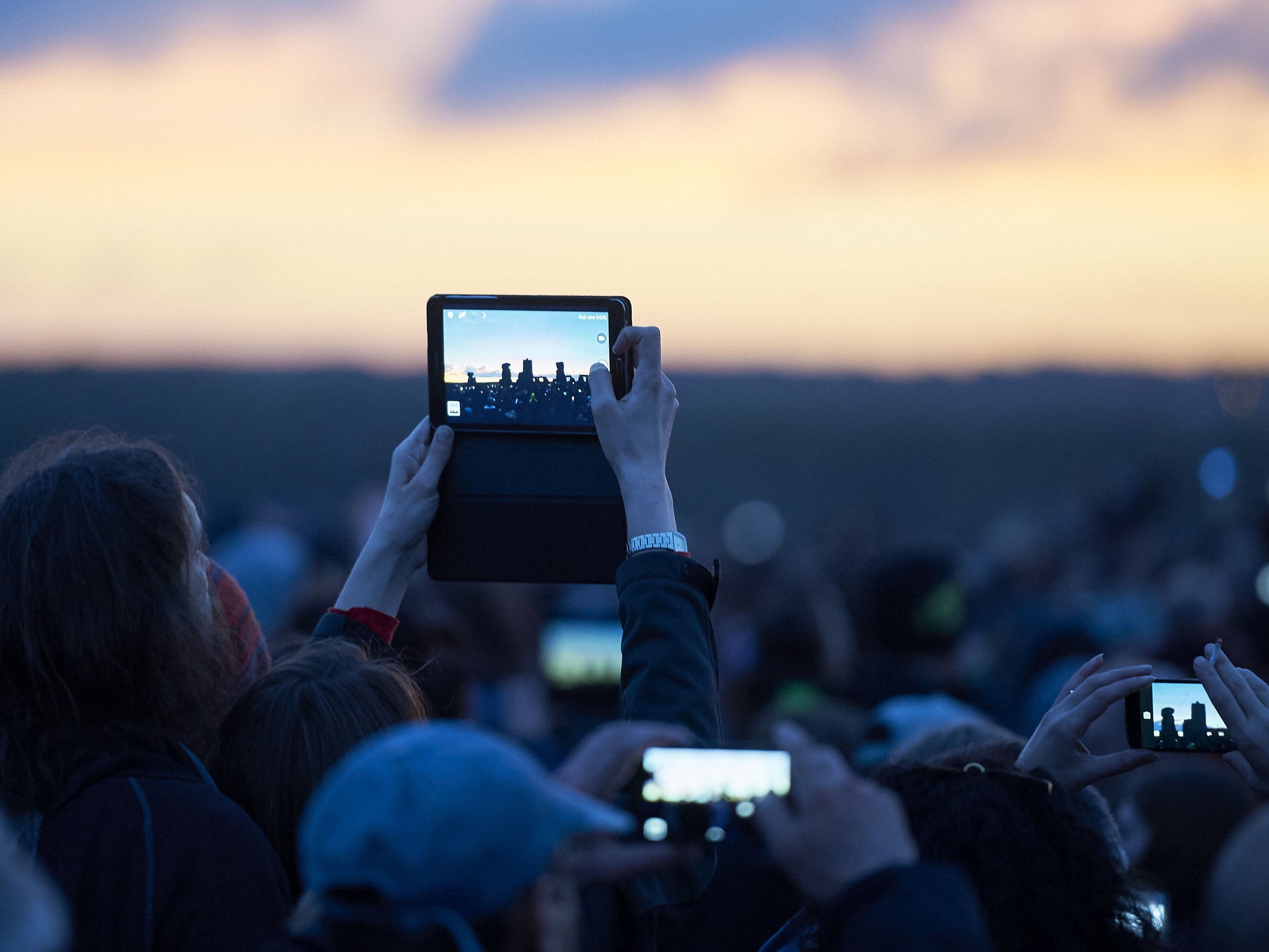 Spectators capture the moment at Stonehenge this morning as part of annual Summer Solstice celebrations