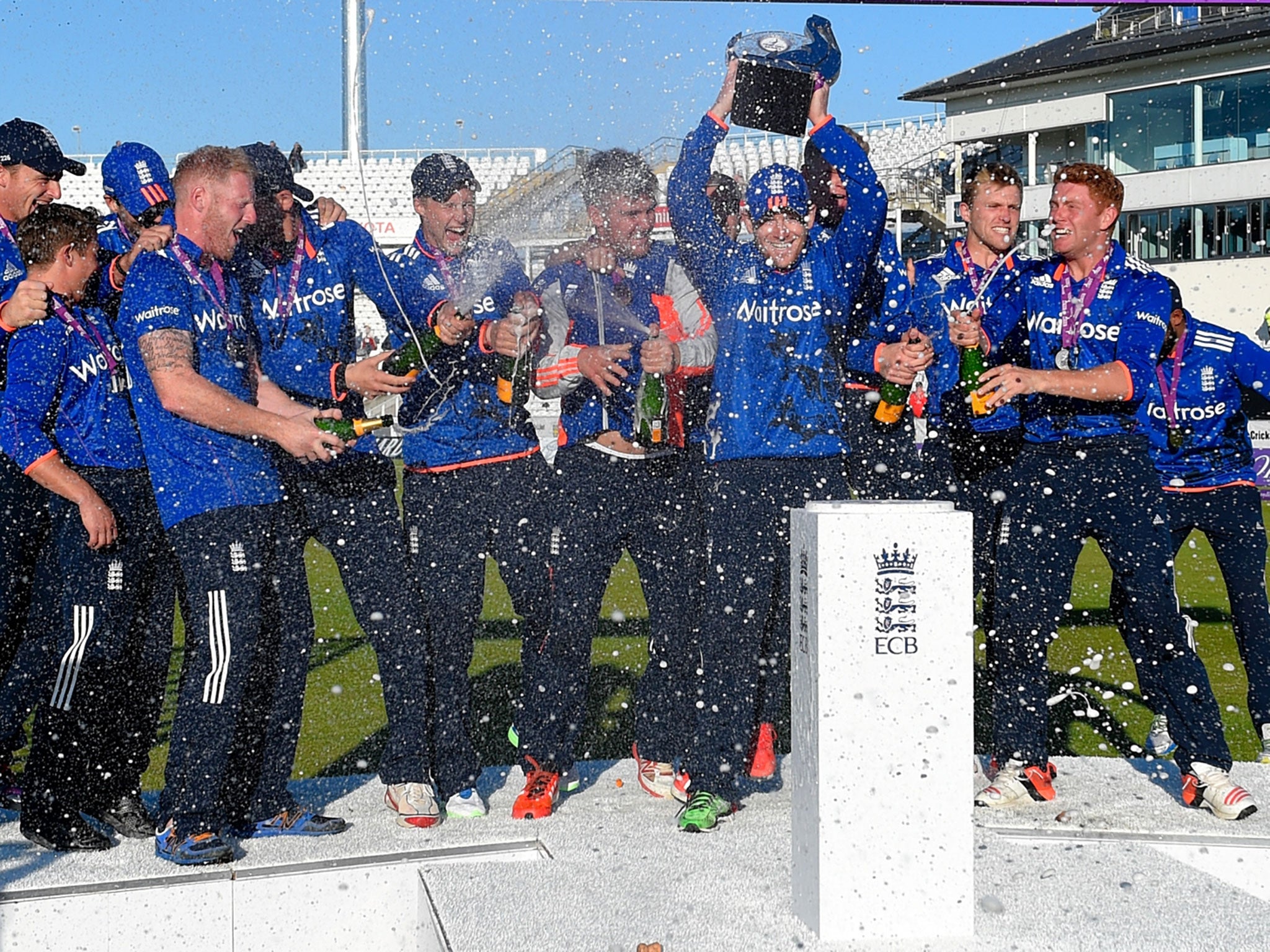 Jubilant England players lift the trophy and spray the bubbly after sealing a thrilling 3-2 one-day series victory over New Zealand at Chester-le-Street