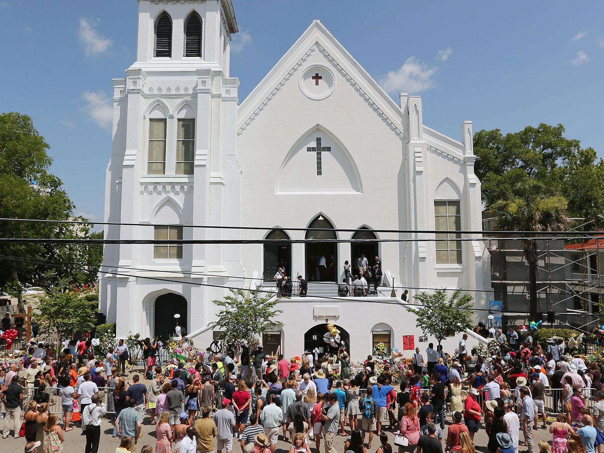 People fill the street in front of the historic Emanuel African American Methodist Church during the Sunday morning service, four days after nine of its members were shot to death in the building in Charleston, South Carolina