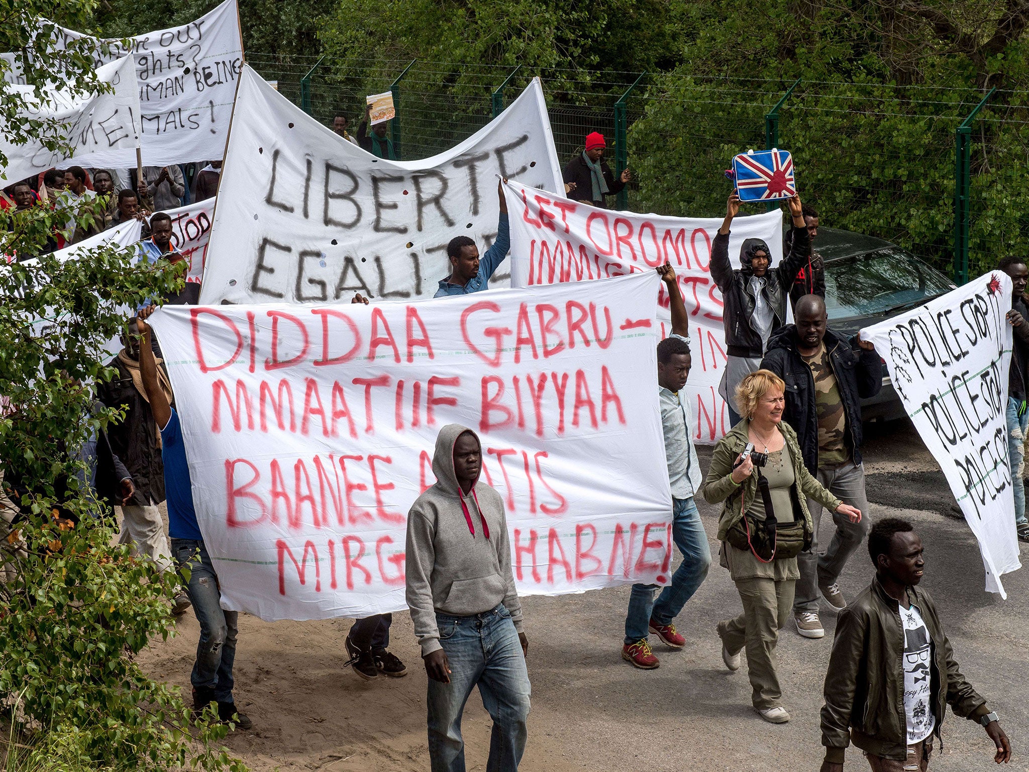 Migrants in Calais take part in World Refugee Day protests