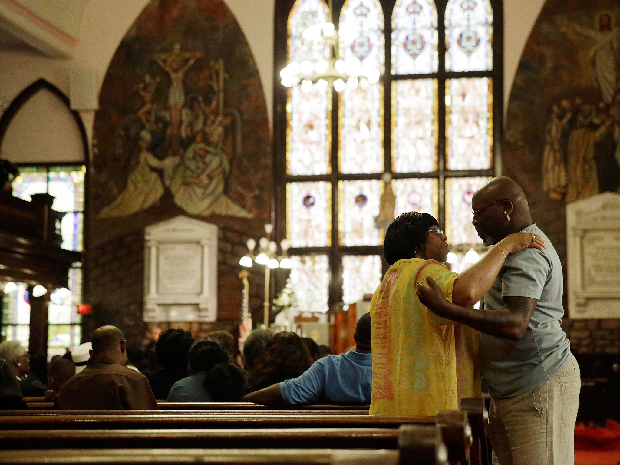 Parishioners embrace before services at the Emanuel African Methodist Episcopal Church in Charleston, South Carolina