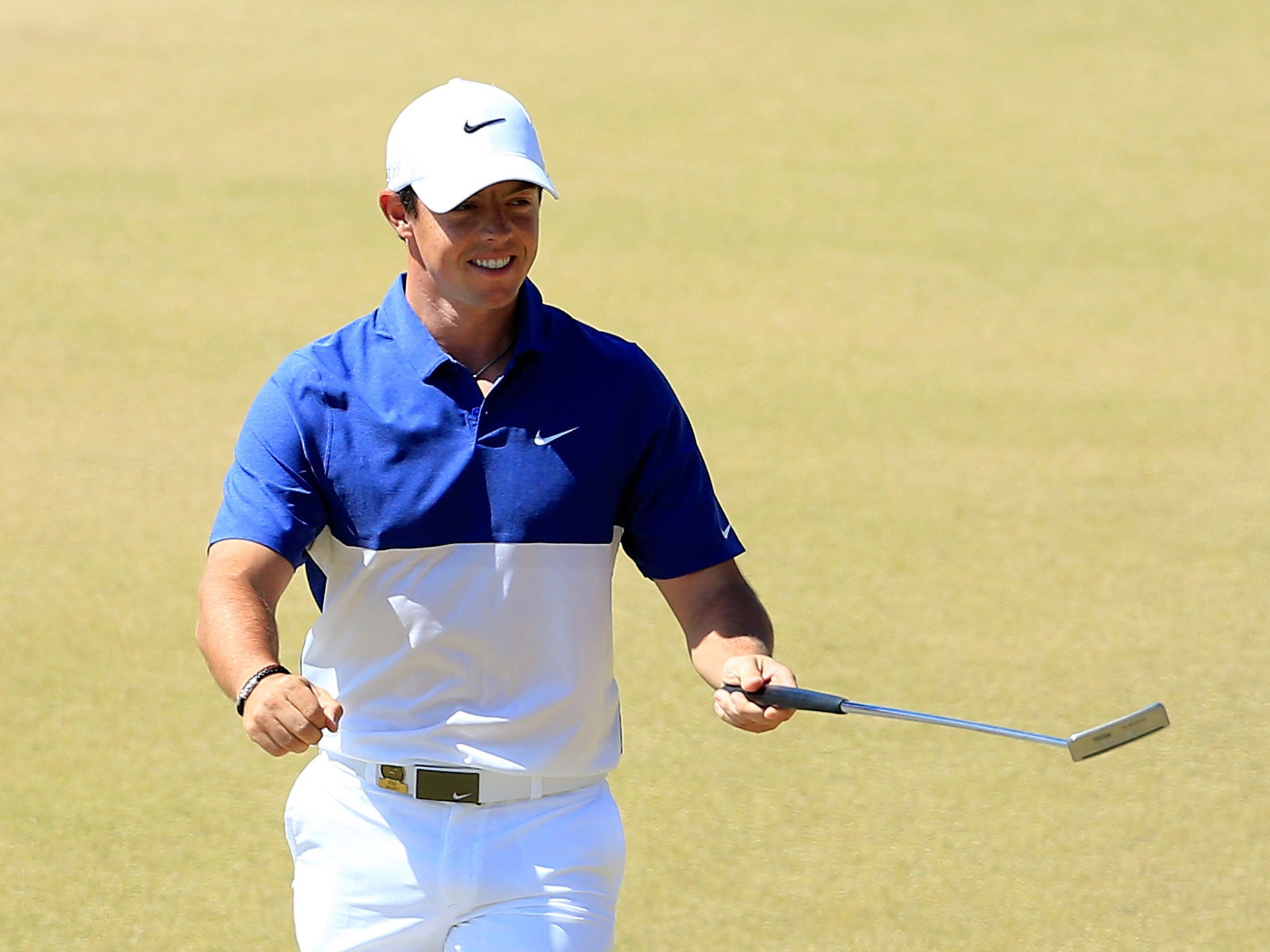 Rory McIlroy smiles after holing a monster 50-foot putt on 13