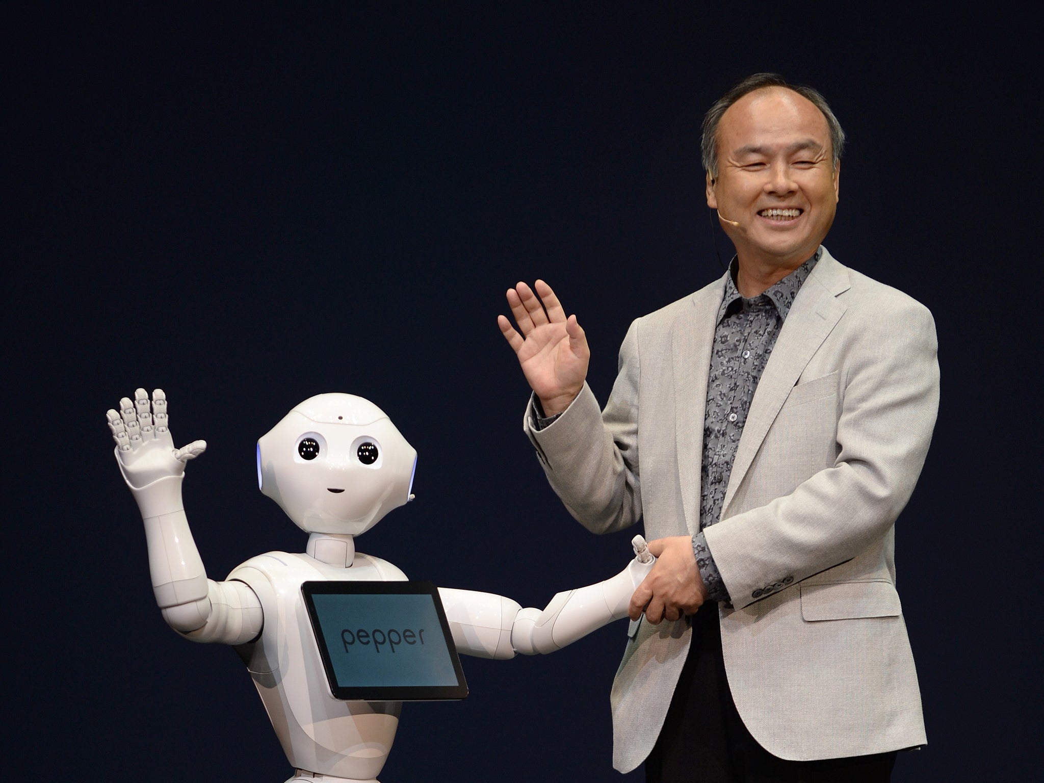 Masayoshi Son, president of Japan's mobile carrier SoftBank, introduces the humanoid robot 'Pepper' equipped with an emotion engine during a press conference in Urayasu, suburban Tokyo, on June 5, 2014