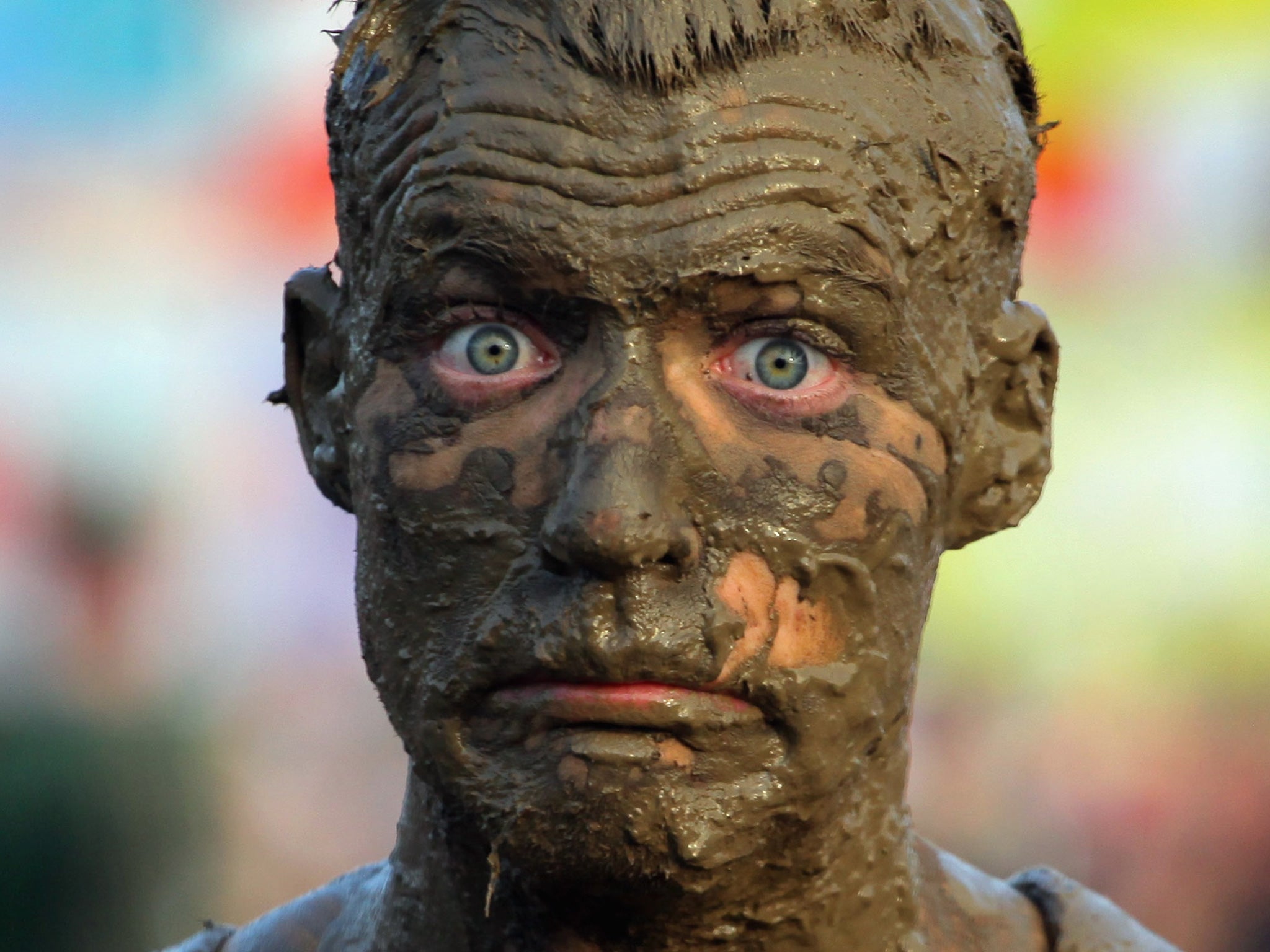 A festival-goer gets covered in mud near the main Pyramid Stage at the Glastonbury Festival on June 26, 2009 in Glastonbury, England