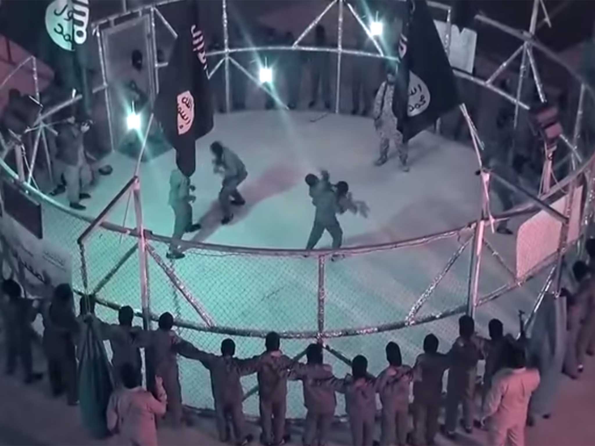 The video shows young boys fighting under the direction of an older militant