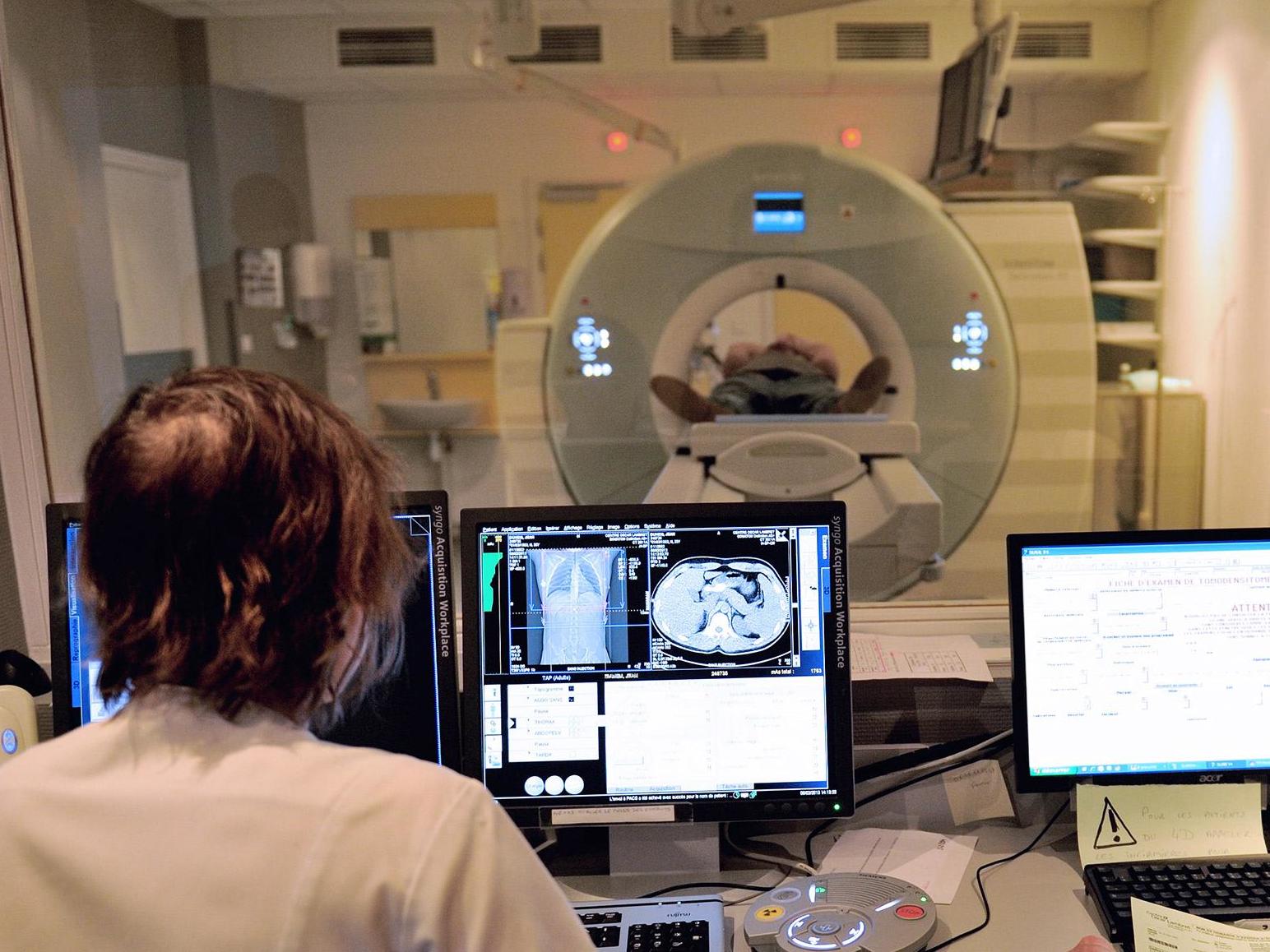 A cancer patient undergoes a CT scan. Around 300,000 new cancer diagnoses are made in the UK every year