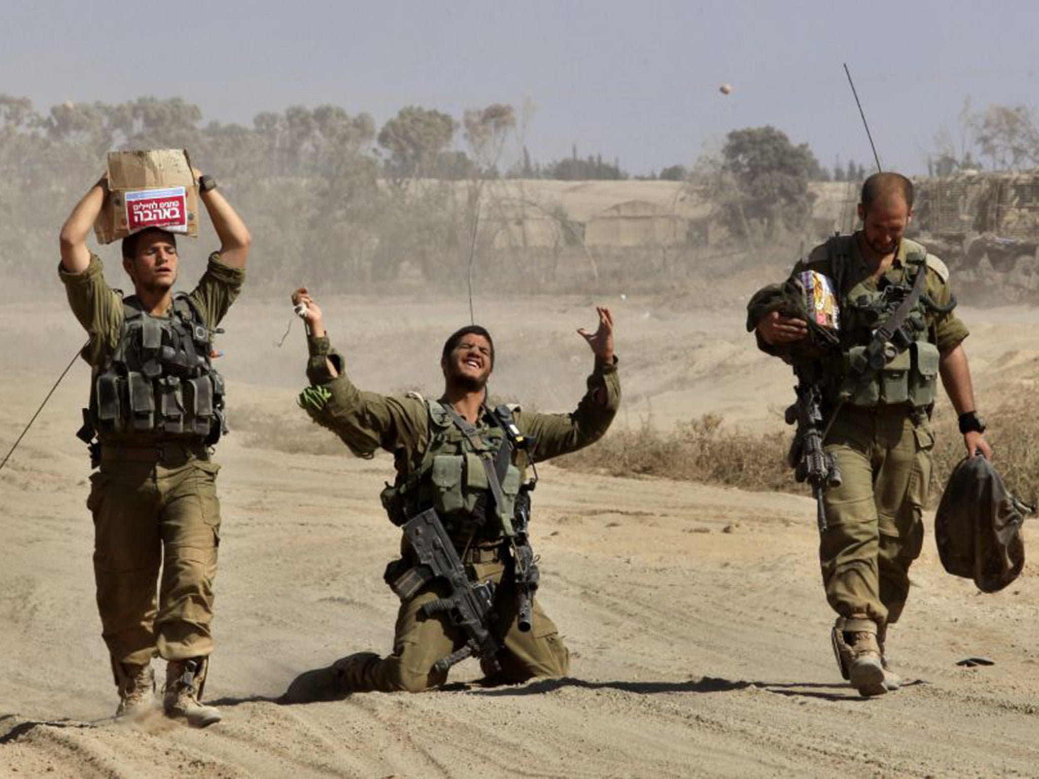An Israeli soldier gestures in relief after returning from the Gaza Strip during the 2014 war