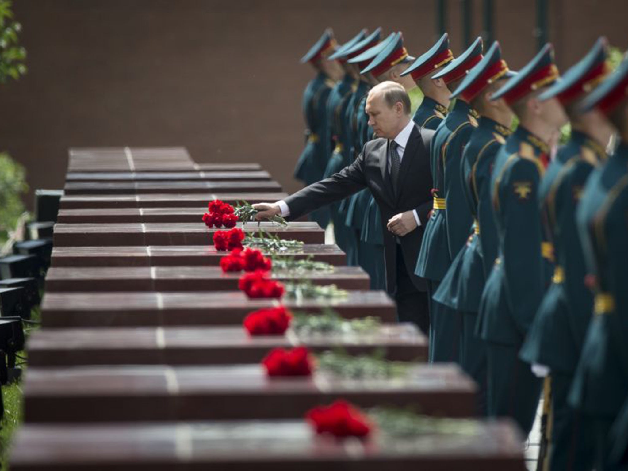 Vladimir Putin takes part in a wreath laying ceremony at the Tomb of the Unknown Soldier outside Moscow on Monday