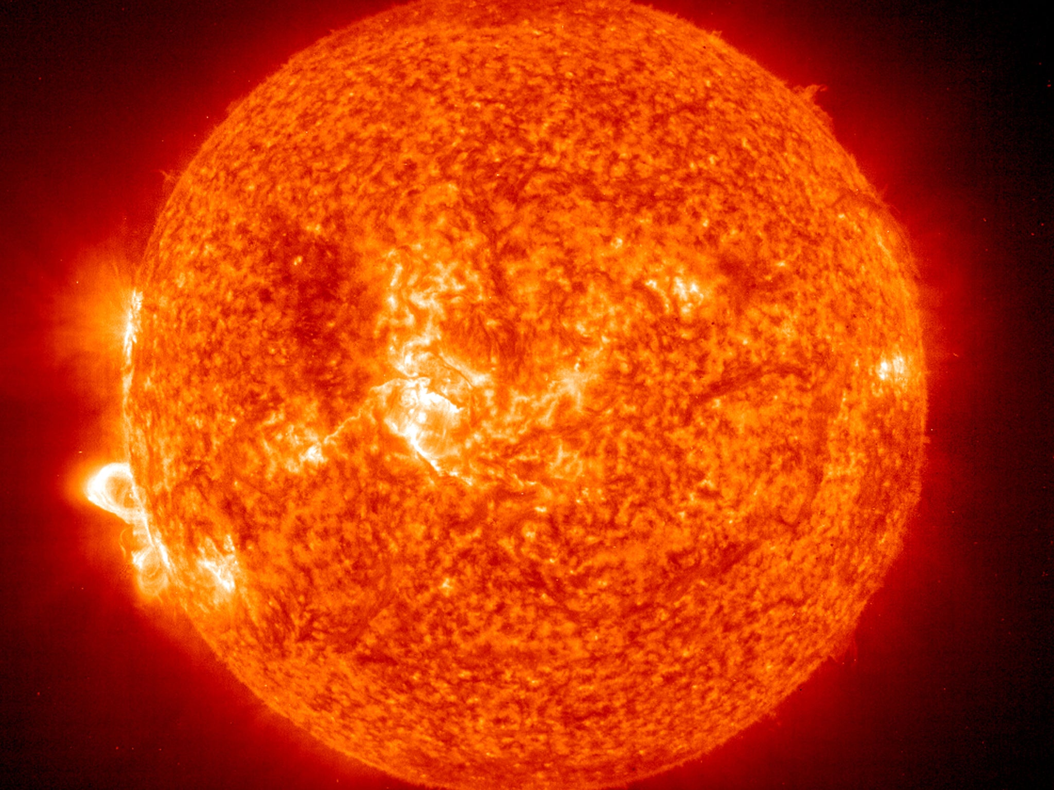 A Solar and Heliospheric Observatory image shows Region 486 that unleashed a record flare on November 18, 2003 on the sun. The spot itself cannot yet be seen but large, hot, gas-filled loops above this region are visible