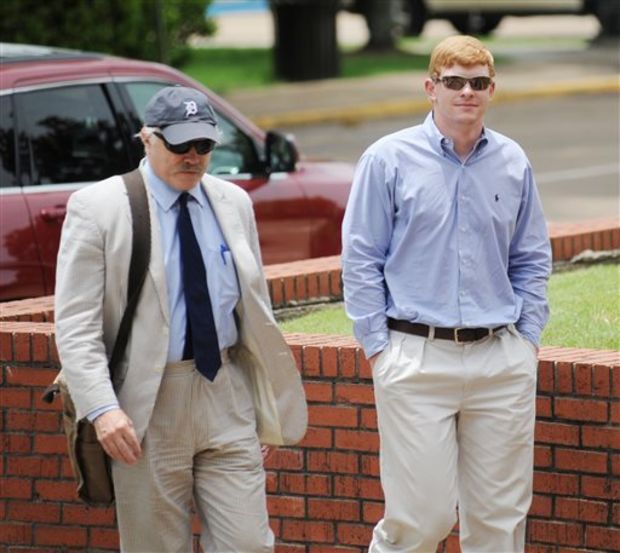 Mr Harris, right, enters the federal court with his attorney