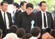 Abe heckled and told to 'go home' during WWII memorial speech