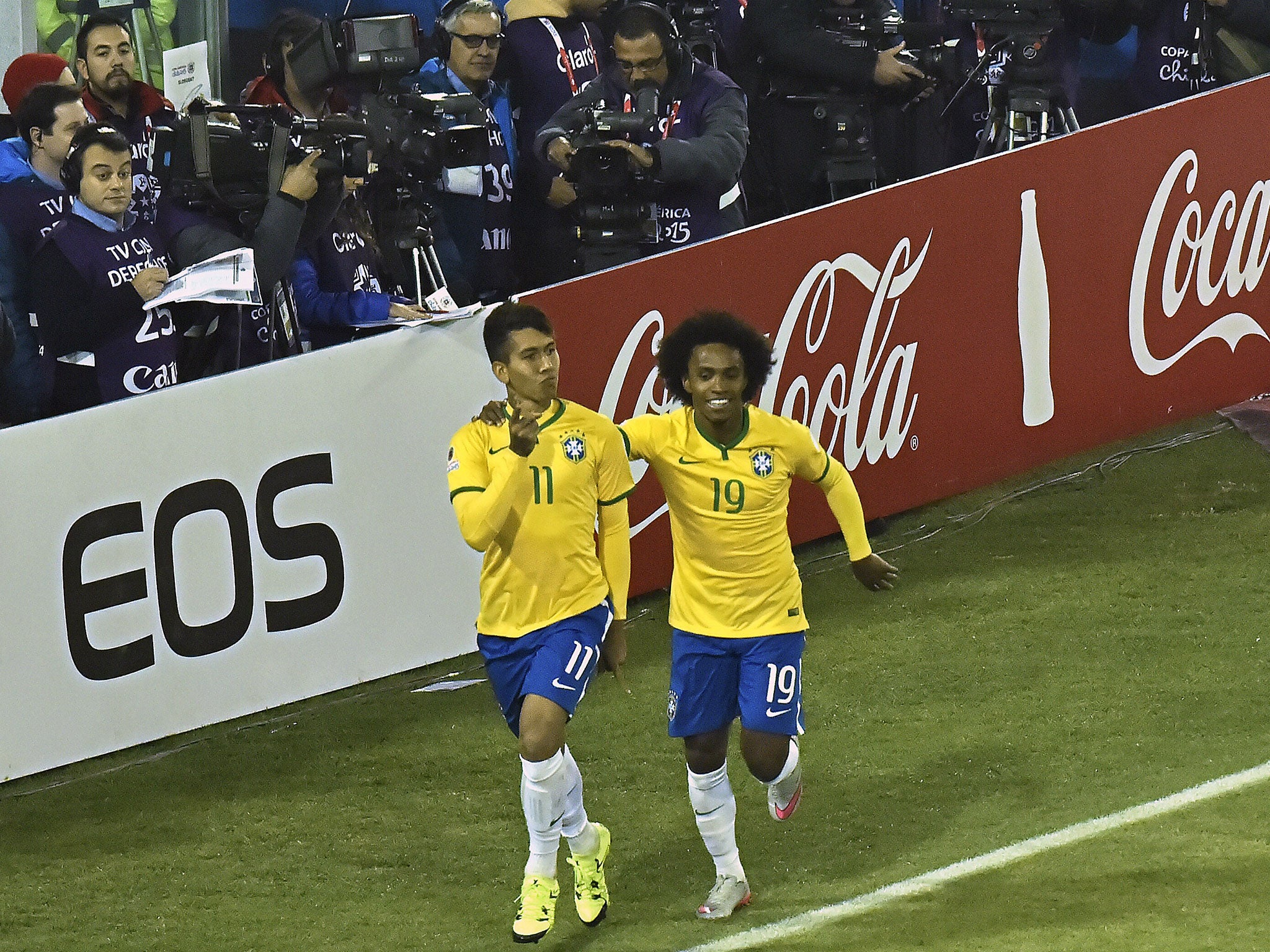 Firmino celebrates his goal against Venezuela with Willian