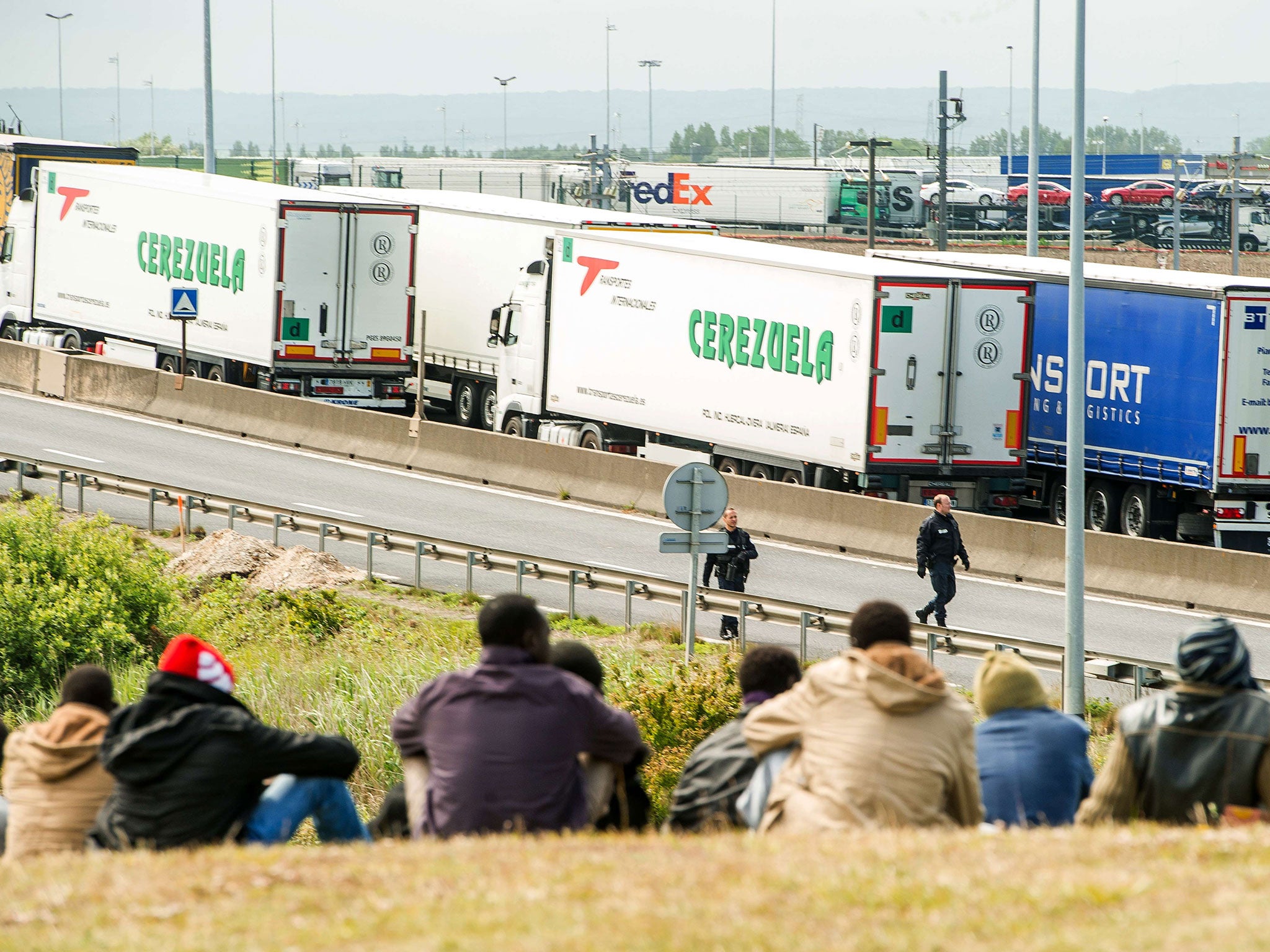 Migrants wait near the A16 highway as they try to access the Channel Tunnel in Calais (Getty)