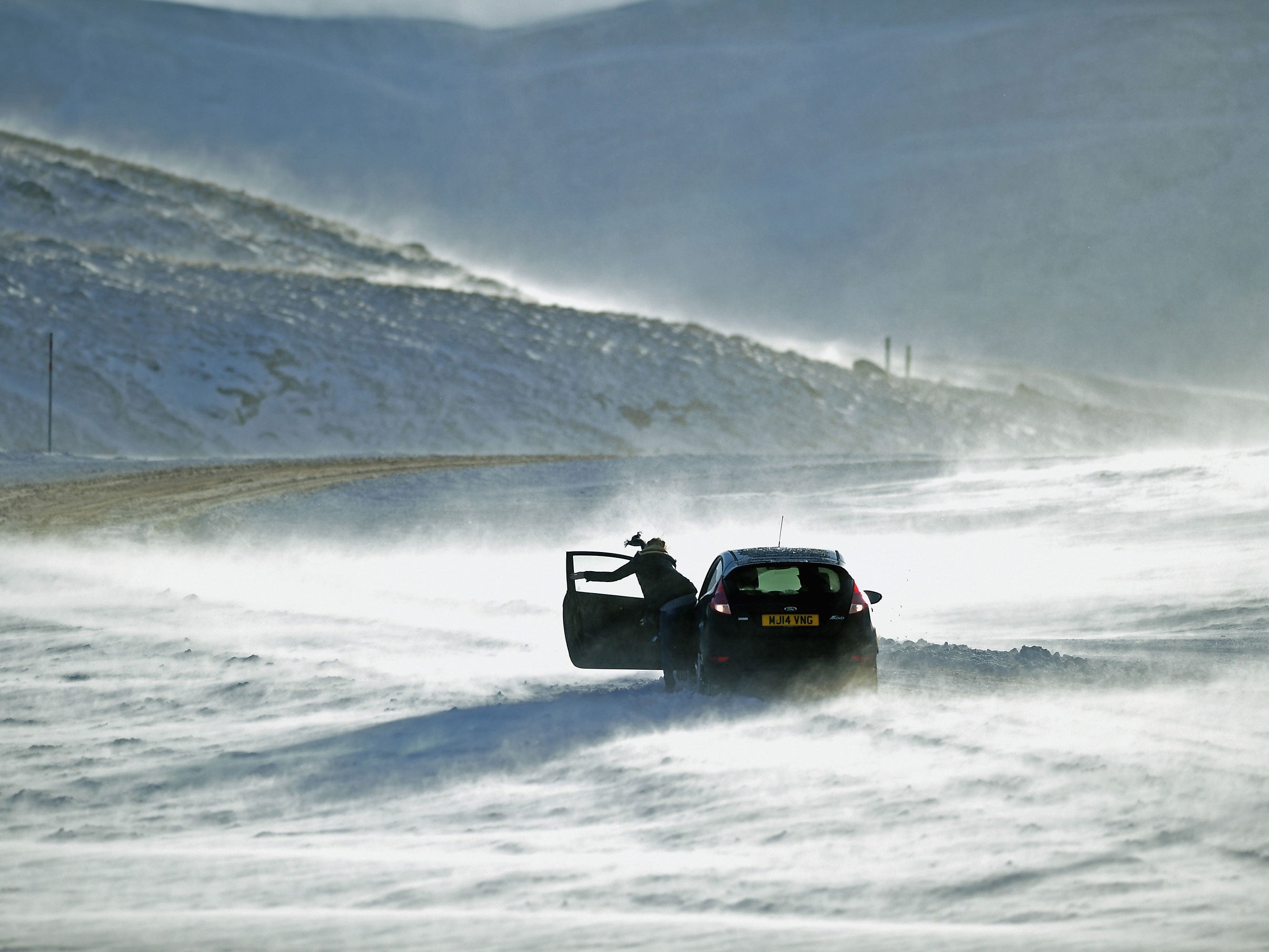 People struggled to push their car in freezing temperatures in the Scottish Highlands in December 2014.