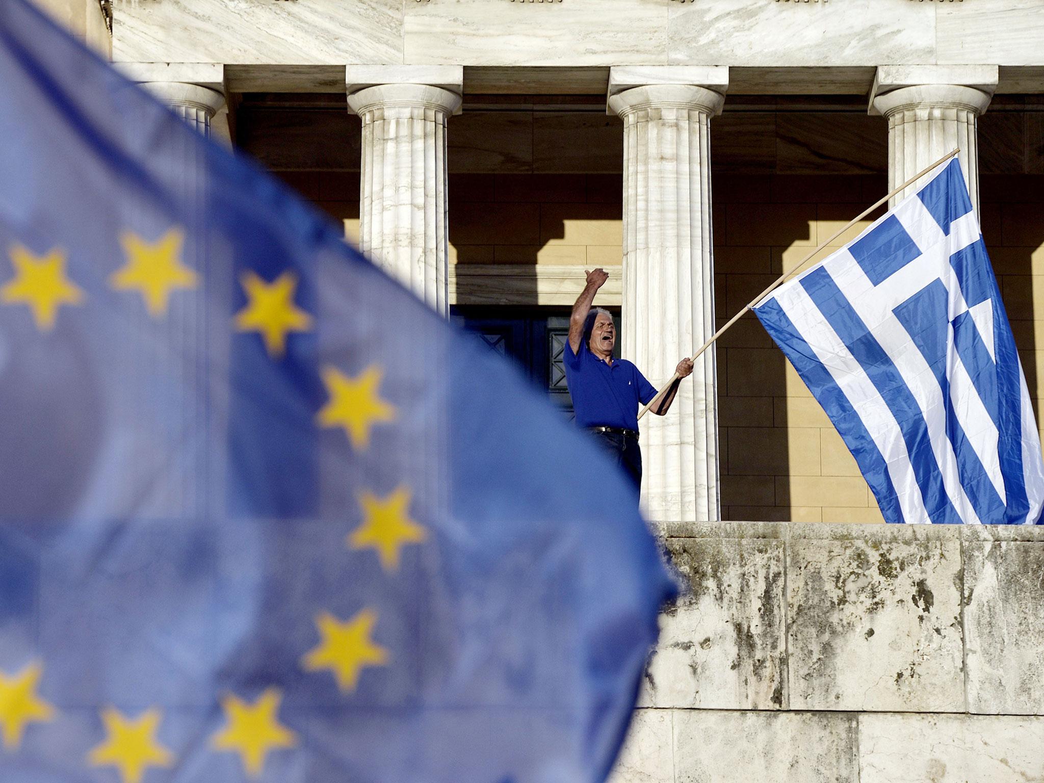 A protester shouts slogans during a pro-European demonstration in front of the Greek parliament in Athens. Greece's international lenders raised hopes for a vital bailout agreement to save Athens from default and a possible euro exit, despite warning no d