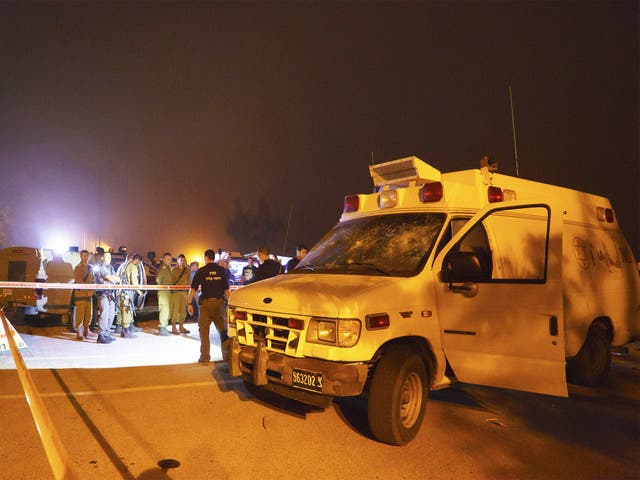 Security forces surround the ambulance after the attack in the Golan Heights on Monday