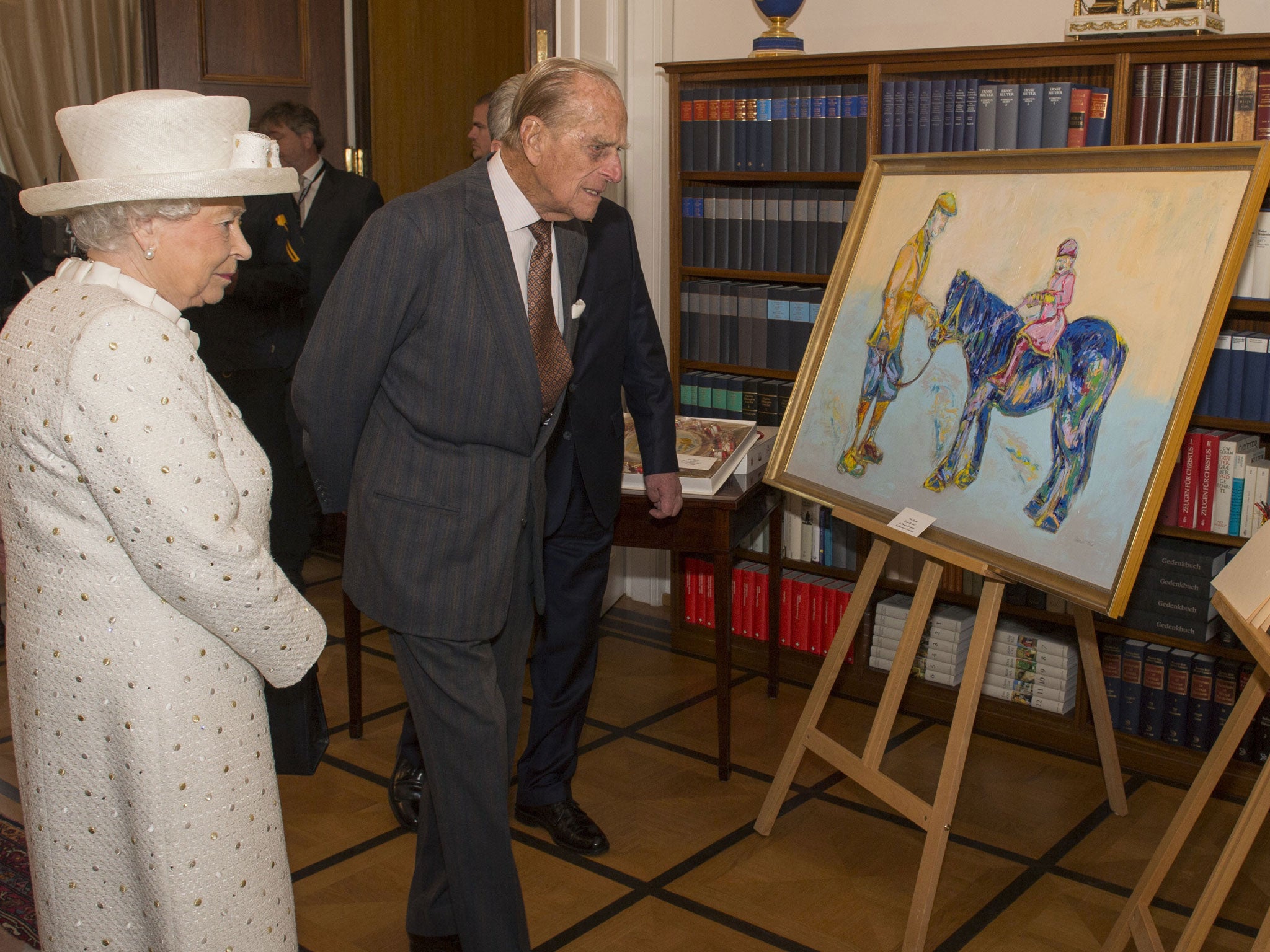 Queen Elizabeth II and the Duke of Edinburgh are presented with a painting by Germany's Federal President Joachim Gauck at his official Berlin residence