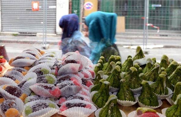 Two Muslim women walk past a bakery in Bordeaux just before Ramadan