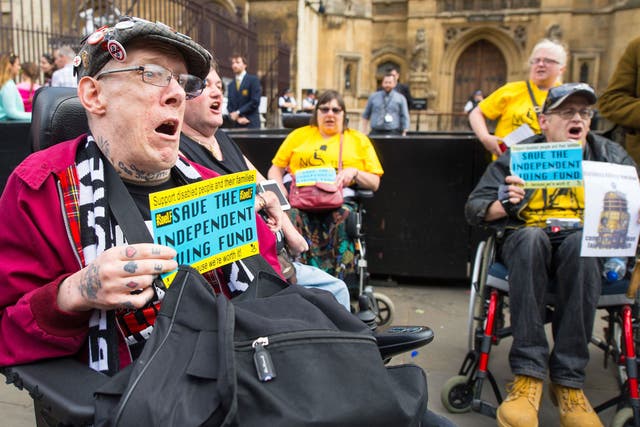 Disability rights campaigners protest outside the Houses of Parliament