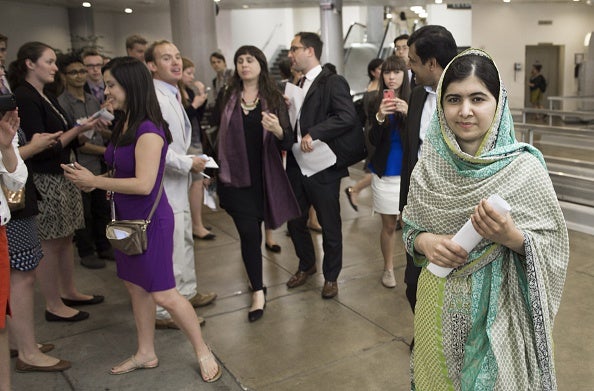 Malala walks through the hallways at the US Capitol after her meeting with Rep. Nancy Pelosi