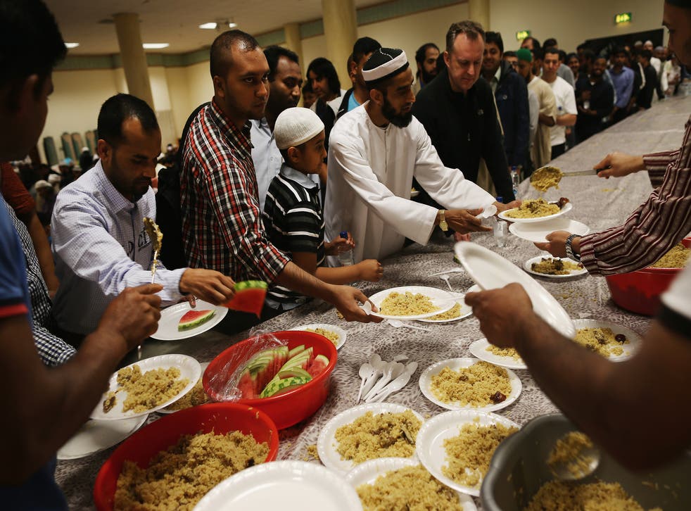 Men eat after a day of fasting at the East London Mosque