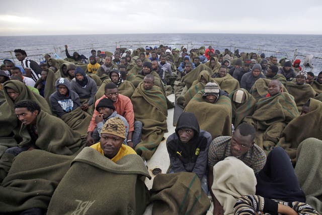 Migrants on the Belgian Navy vessel Godetia after they were saved during a search and rescue mission in the Mediterranean off the Libyan coast on Wednesday