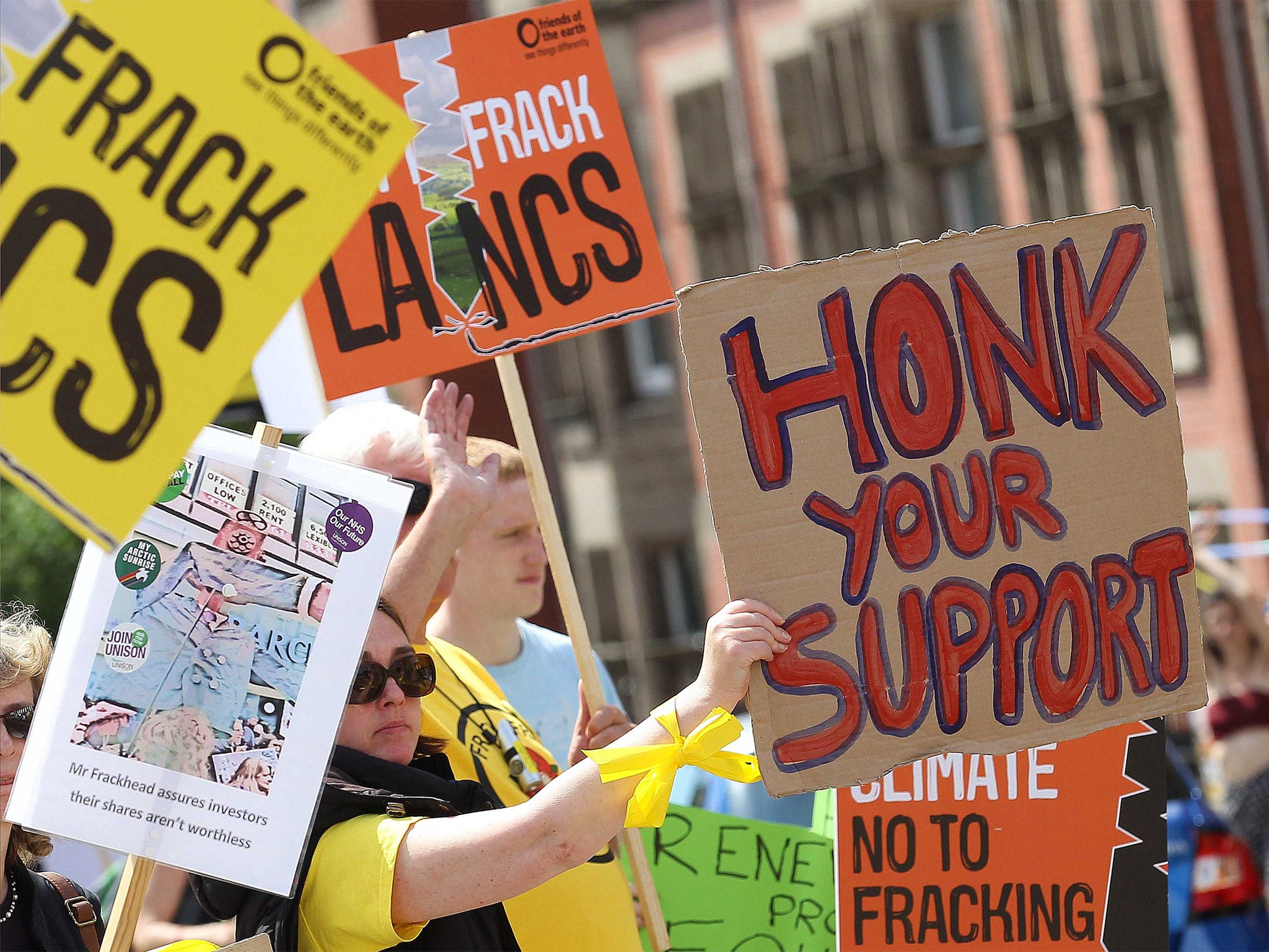 Anti-fracking protesters state their case during a demonstration outside of a meeting in Preston County Hall