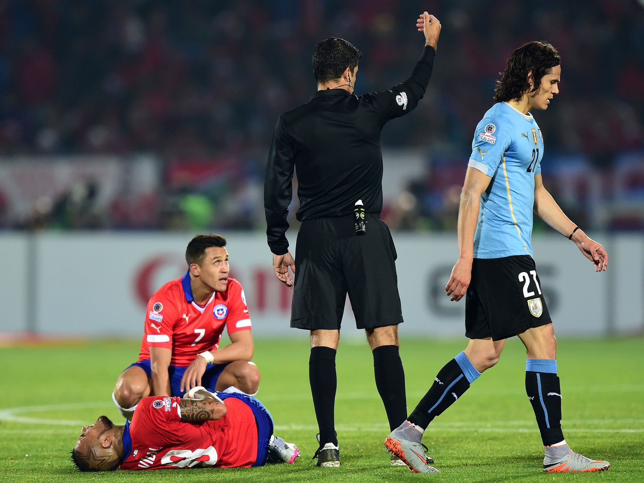 Cavani walks away after being booked for a foul on Vidal