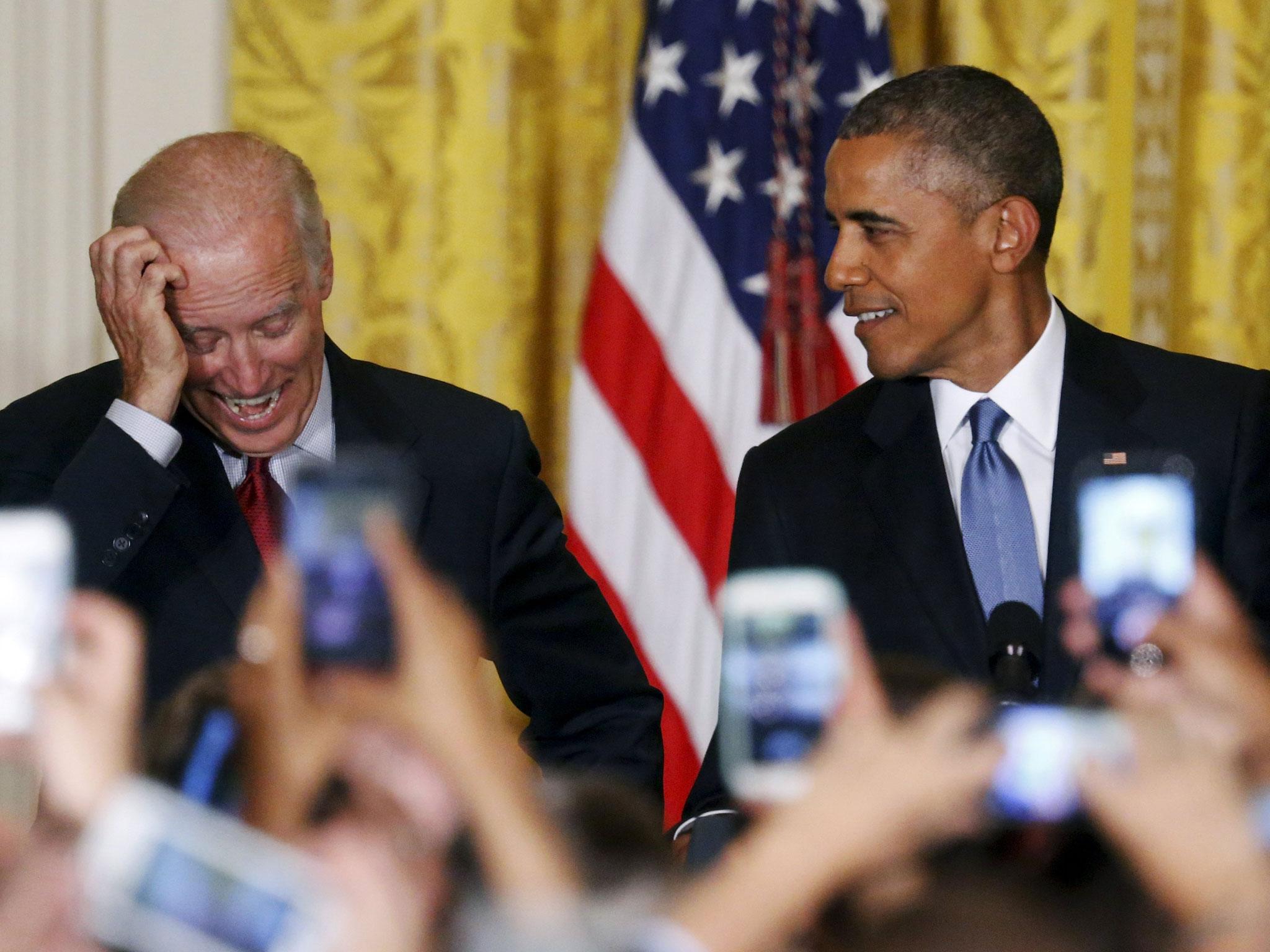 Obama and Vice President Joe Biden react after a heckler was removed for their extended interruption (Reuters)